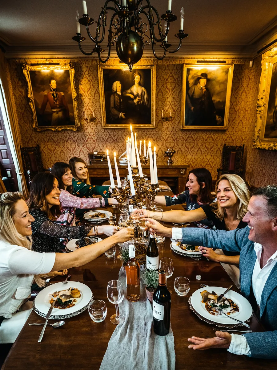 Colleagues raising a toast at a candlelit team dinner